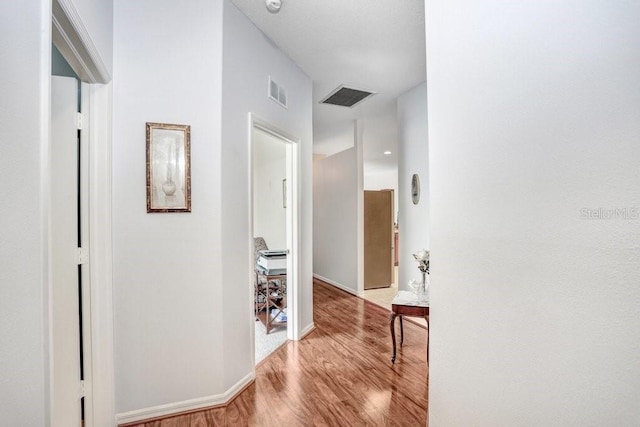 hall with light hardwood / wood-style floors