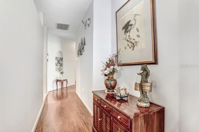 corridor with light hardwood / wood-style flooring