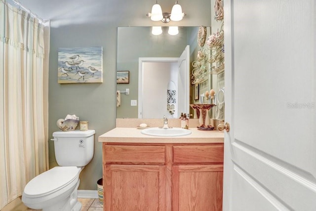 bathroom with vanity, tile patterned floors, an inviting chandelier, and toilet