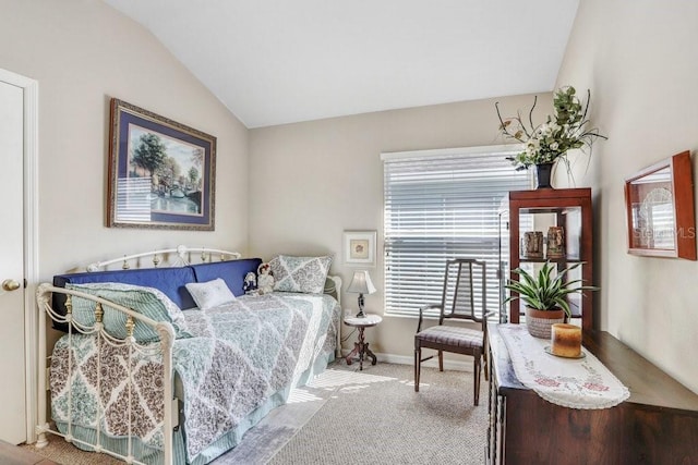 carpeted bedroom featuring vaulted ceiling