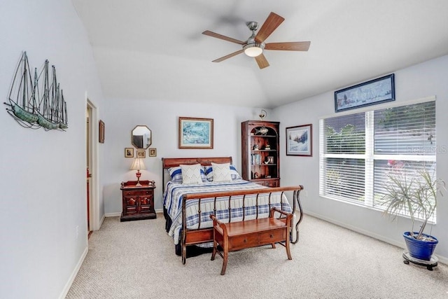 bedroom with lofted ceiling, light carpet, and ceiling fan