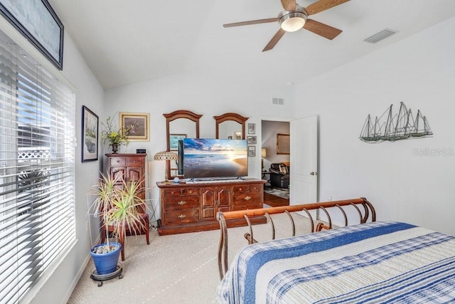 bedroom with light carpet, lofted ceiling, and ceiling fan