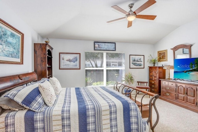 carpeted bedroom featuring ceiling fan and vaulted ceiling