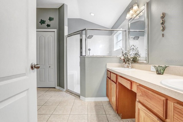 bathroom featuring tile patterned flooring, vanity, a shower with shower door, and lofted ceiling