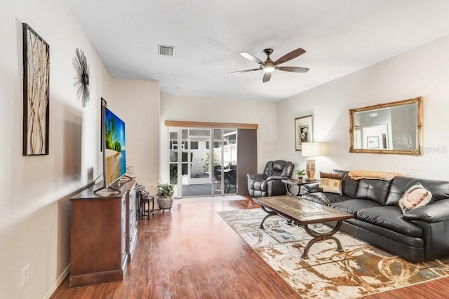 living room featuring wood-type flooring and ceiling fan