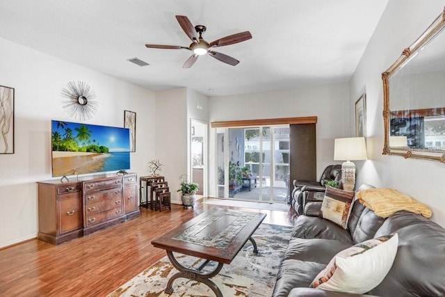 living room featuring hardwood / wood-style floors and ceiling fan