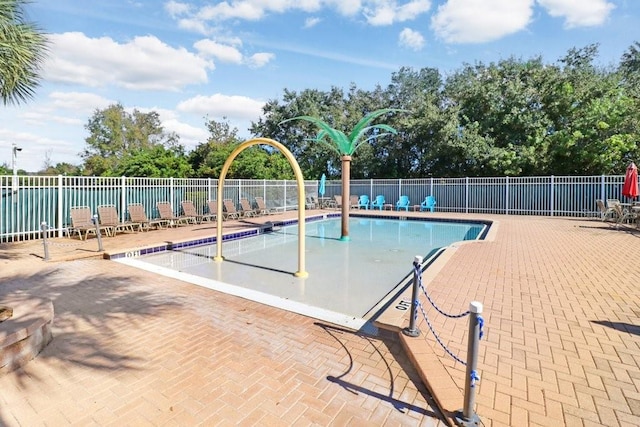 view of swimming pool with a playground