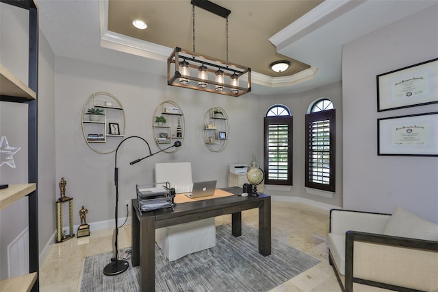 office space with baseboards, a tray ceiling, and crown molding