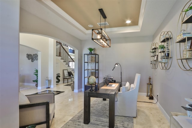office area featuring a tray ceiling, arched walkways, baseboards, and visible vents