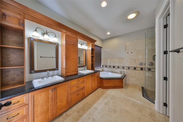 full bathroom featuring a bath, a sink, a shower stall, double vanity, and recessed lighting