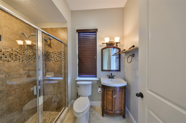 full bath with baseboards, toilet, vanity, tile patterned flooring, and a stall shower