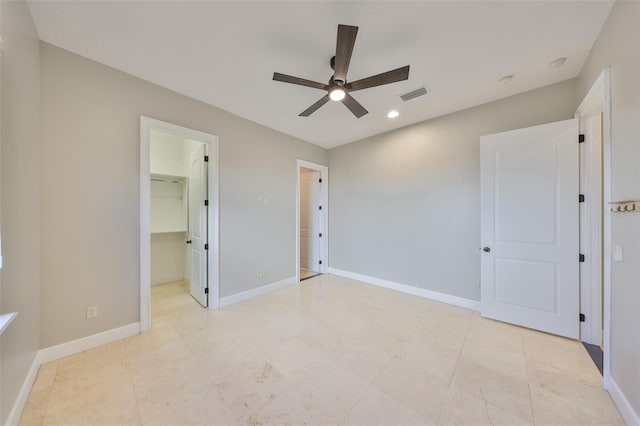 unfurnished bedroom featuring baseboards, recessed lighting, a walk in closet, visible vents, and ceiling fan