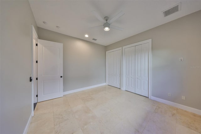 unfurnished bedroom with two closets, ceiling fan, visible vents, recessed lighting, and baseboards