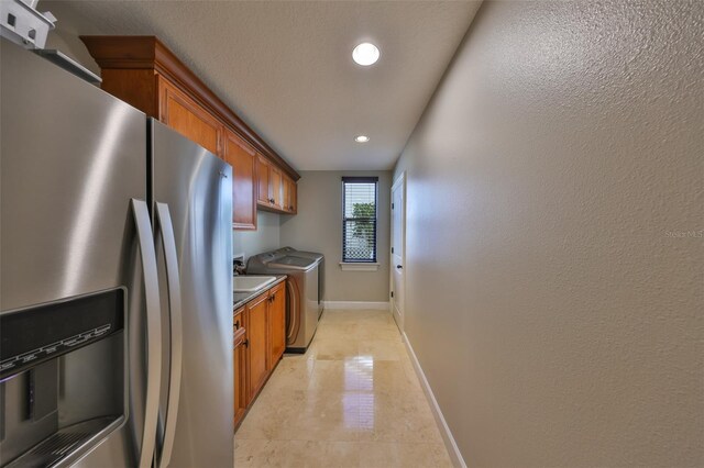 kitchen featuring stainless steel fridge with ice dispenser, recessed lighting, brown cabinets, and baseboards