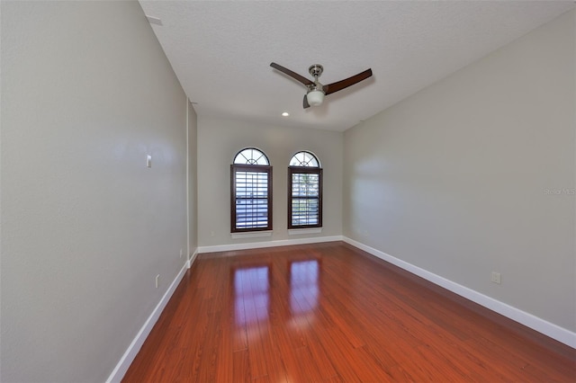 unfurnished room with recessed lighting, dark wood-type flooring, baseboards, and ceiling fan