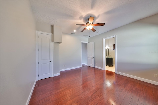 unfurnished bedroom with wood finished floors, baseboards, and recessed lighting