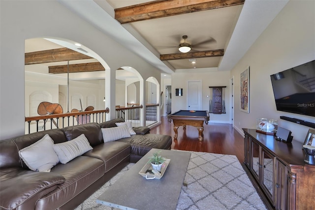 living room with arched walkways, ceiling fan, beamed ceiling, billiards, and wood finished floors