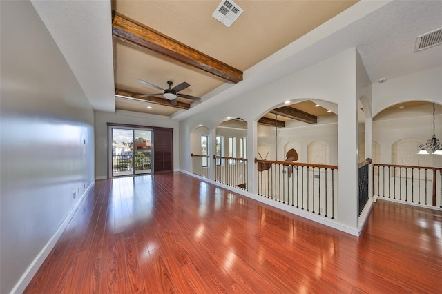unfurnished living room with visible vents, baseboards, wood finished floors, and ceiling fan