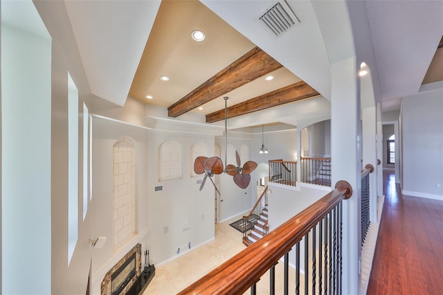 hall with visible vents, baseboards, an upstairs landing, beam ceiling, and recessed lighting