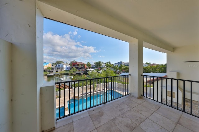 balcony with a water view and a residential view