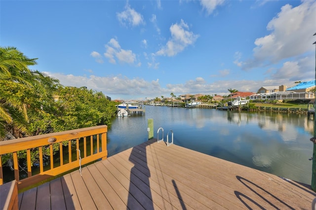 view of dock with a water view and a residential view