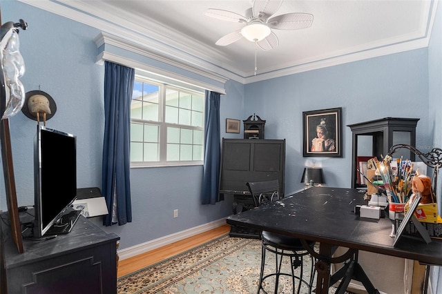 office area with light wood-style floors, ceiling fan, baseboards, and crown molding