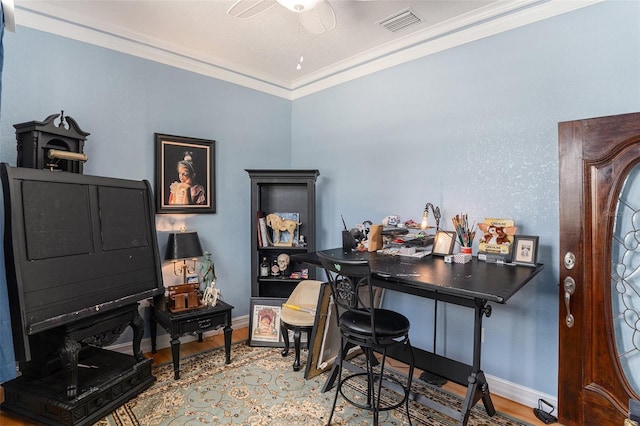 home office featuring baseboards, visible vents, crown molding, and wood finished floors