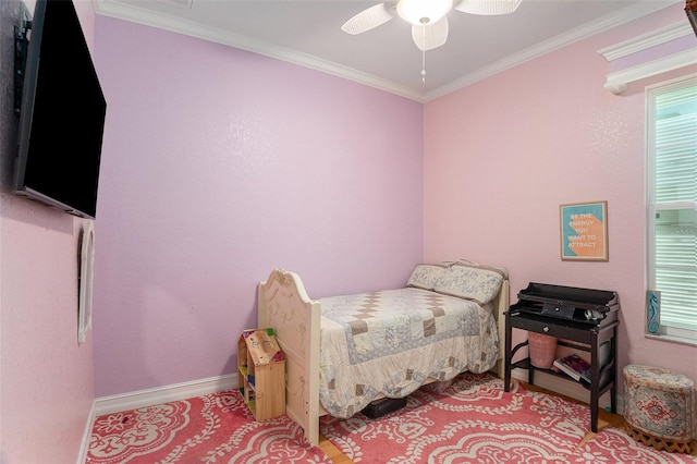 bedroom featuring baseboards, a ceiling fan, and crown molding