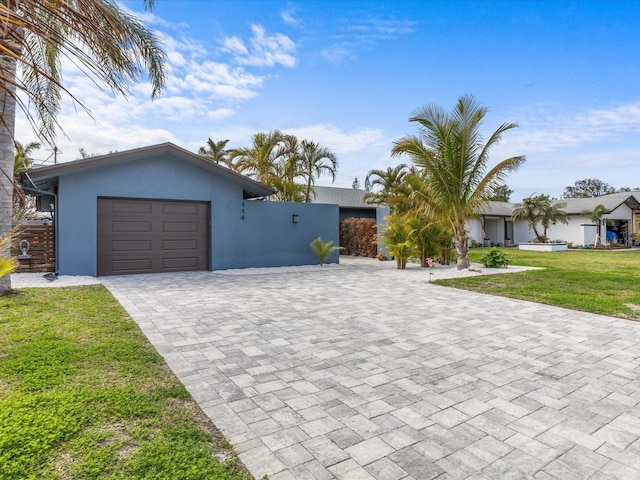 view of front of home featuring a garage and a front yard