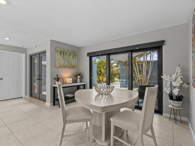 tiled dining space featuring french doors