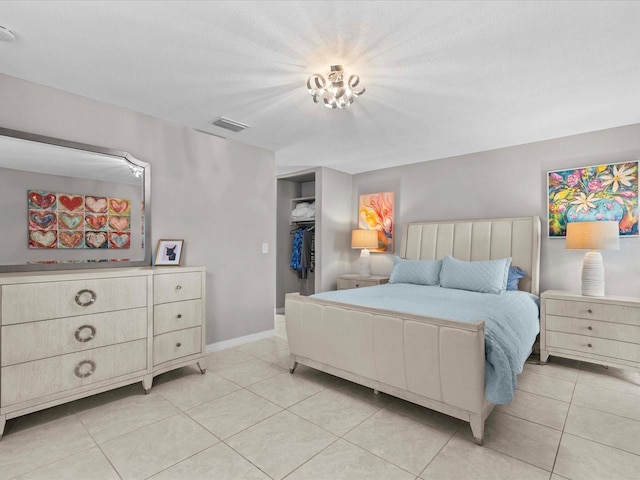 tiled bedroom with a closet