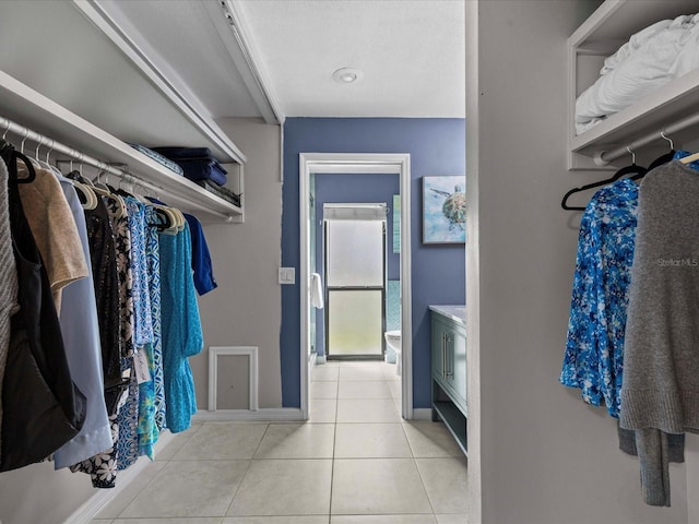 spacious closet featuring light tile patterned floors