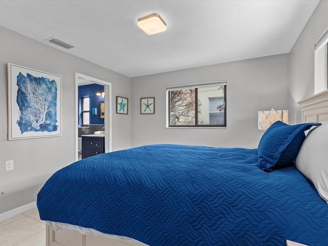 tiled bedroom featuring connected bathroom