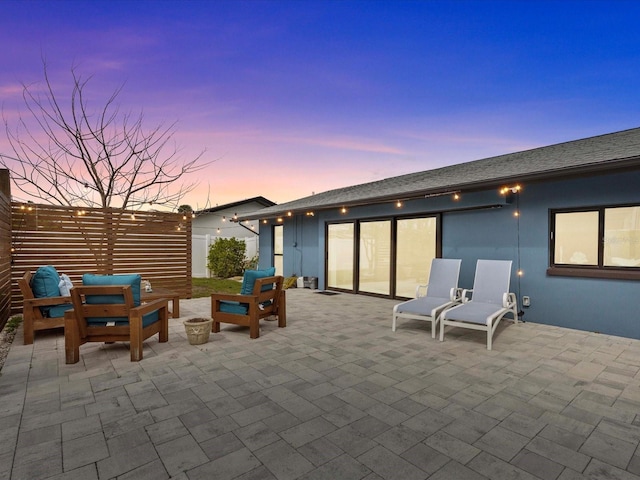 view of patio terrace at dusk