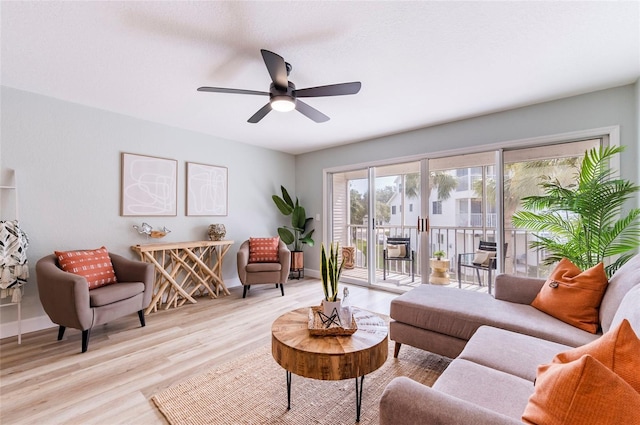 living room featuring ceiling fan and light wood-type flooring