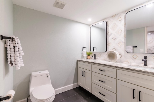 bathroom with vanity, toilet, tile patterned flooring, and decorative backsplash