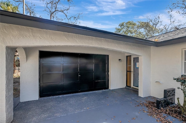 doorway to property with a garage