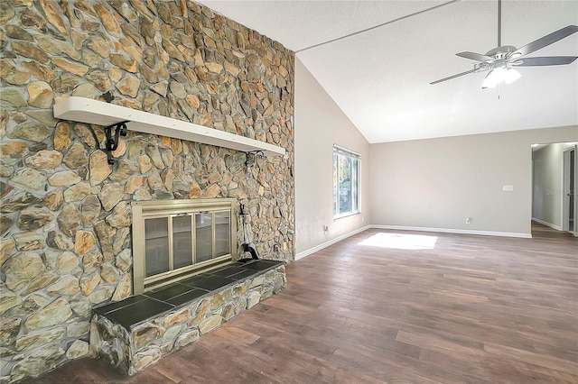 unfurnished living room with dark wood-type flooring, ceiling fan, high vaulted ceiling, a fireplace, and a textured ceiling