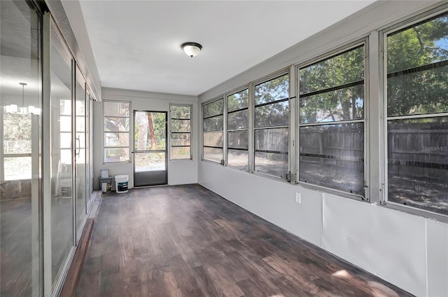 unfurnished sunroom featuring a chandelier