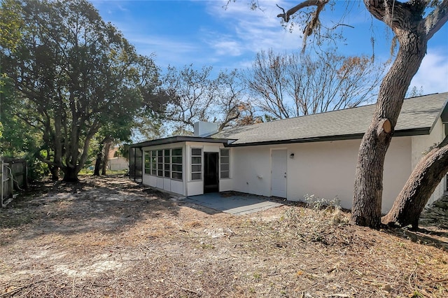 back of property with a patio area and a sunroom