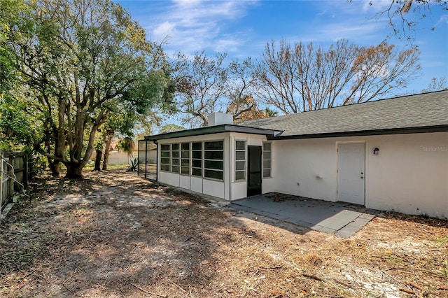 rear view of house with a patio area and a sunroom