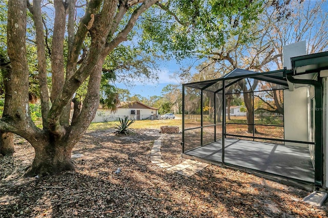 view of yard featuring glass enclosure