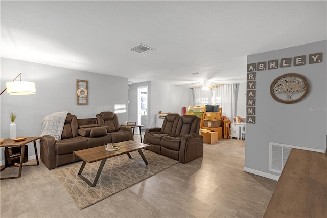 living room with baseboards and visible vents