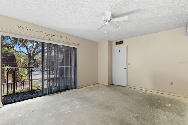 unfurnished room with ceiling fan, concrete floors, and a textured ceiling