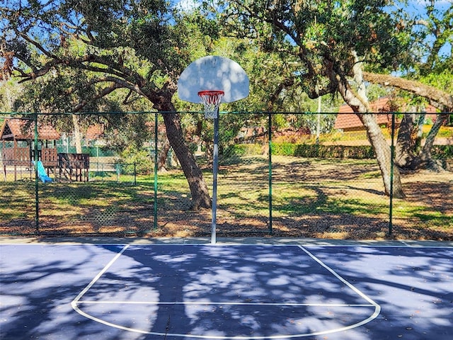 view of sport court with a playground