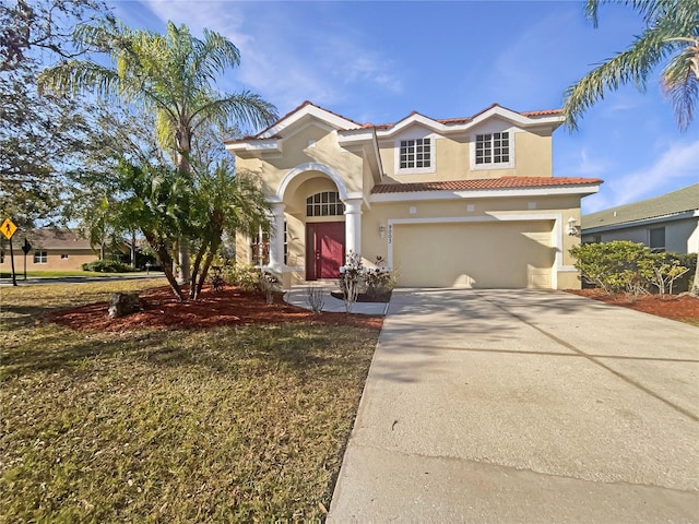 mediterranean / spanish-style house featuring a garage and a front lawn