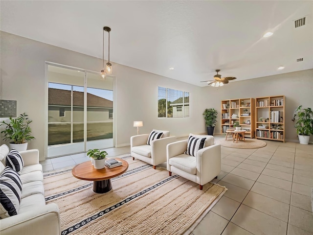 tiled living room featuring ceiling fan and a healthy amount of sunlight