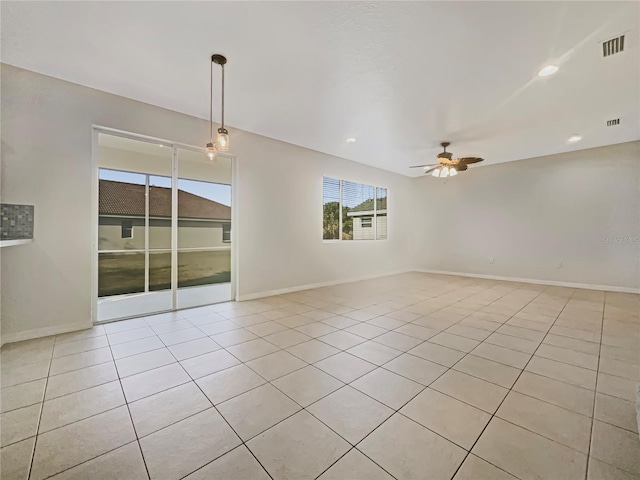 empty room with light tile patterned flooring and ceiling fan