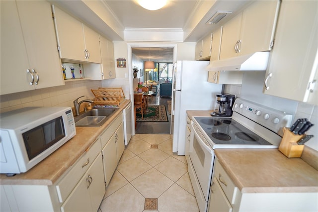 kitchen featuring light tile patterned flooring, sink, a raised ceiling, white appliances, and decorative backsplash