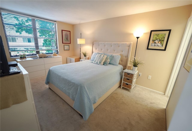 bedroom featuring light carpet